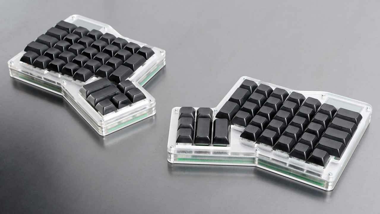 Photo of ErgoDox Infinity ergonomic mechanical keyboard, with blank black DSA keycaps and acrylic case